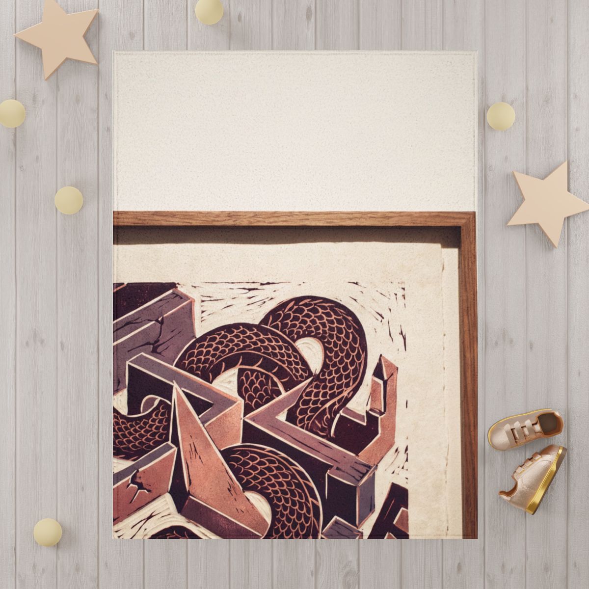 Manta infantil con linograbado de serpiente geométrica