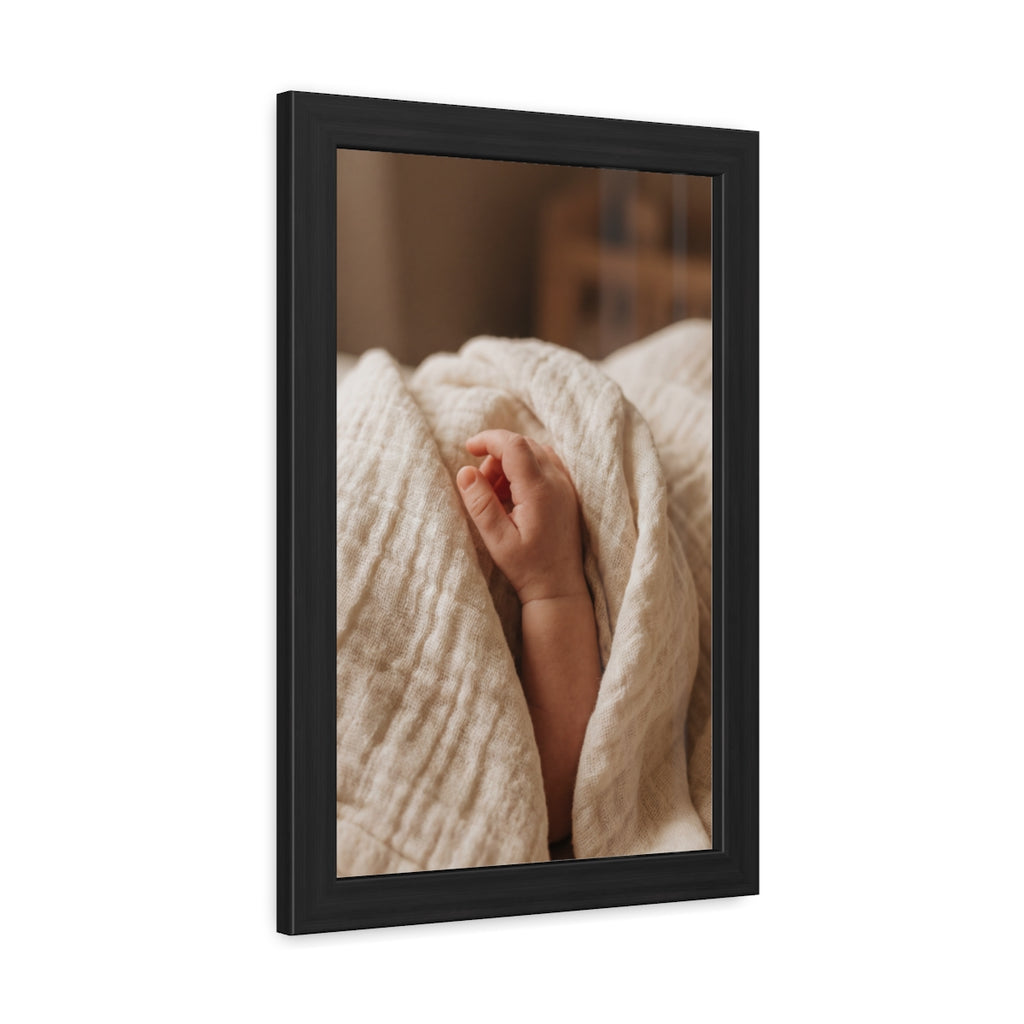 Framed Posters - Tender Newborn Hand in Soft Muslin Blanket...